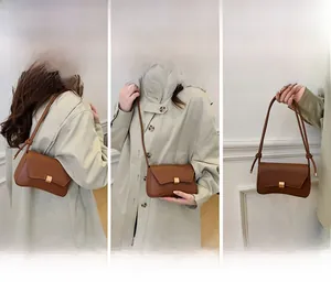 Three-way carry demonstration of caramel leather baguette bag with gold buckle