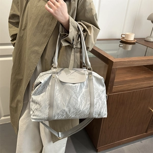 Silver grey large capacity travel bag with metallic texture and adjustable shoulder strap