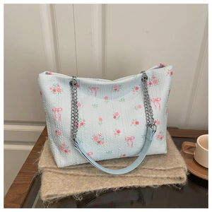 Detailed macro view of light blue bubble fabric texture with floral and bow prints