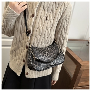 Détail du sac à bandoulière léopard avec chaîne métallique et fermeture éclair fine
