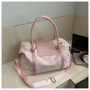 Sac de voyage rose texturé avec poignées en cuir dans un décor de bureau moderne