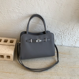 Dark grey pebble leather handbag with top handles and a metal turn-lock closure