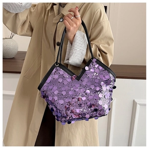Sparkly purple sequin tote bag shown in a real-life fashion setting with khaki trench coat