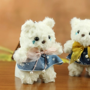 Detailed view of cute plush teddy bear charms in floral and polka dot dresses
