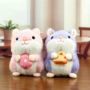 Detail of cute plush hamster keychains in pink and purple holding snacks with soft texture
