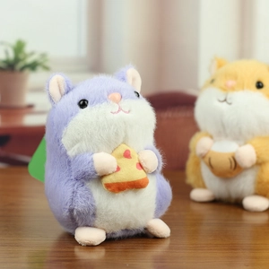 Detail of a purple plush hamster keychain holding a pizza slice with soft velvet texture