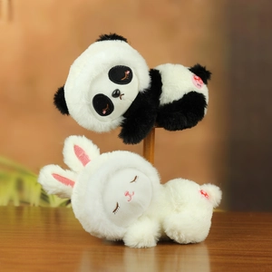 Detail of plush sleeping panda and white rabbit toys with soft long fur and embroidery