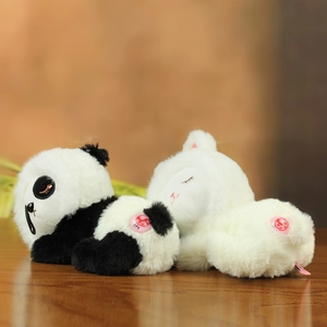 Close-up of soft panda and white kitten plush toys featuring fluffy texture and brand tag