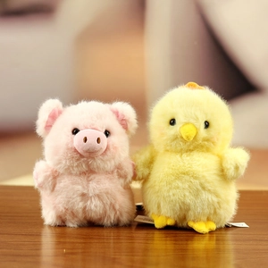 Close-up of soft plush pig and chick toys with fluffy texture and beaded eyes