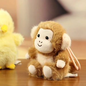 Close-up of a soft plush monkey charm with a high-quality TOOT handmade brand tag
