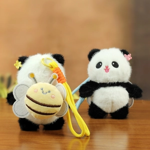 Close-up of plush panda keychains with woven lanyards and decorative bee and flower details