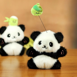 Cute plush panda toy with green zongzi pendant on top, black and white soft stuffed animal