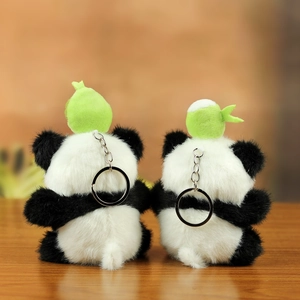 Detailed back view of plush panda keychains with green leaf accents and silver ring