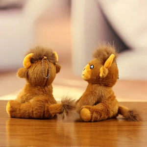 Detailed view of two cute camel plush keychains in brown and yellow with metal ball chains