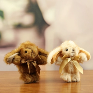 Detailed close-up of cute faux mink fur rabbit plush charms with satin ribbon bows