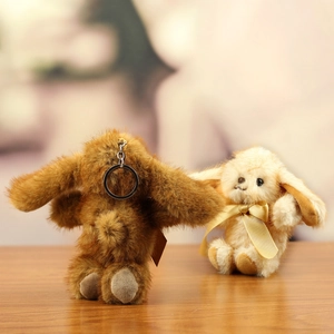 Detailed view of plush bunny keychains in brown and beige with soft faux mink fur texture