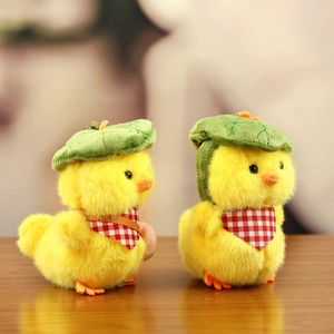 Detail of plush yellow duck pendants with green leaf hats and red checkered scarves