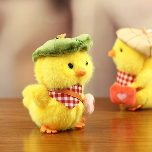 Close-up of plush yellow duck charm featuring a green beret and red checkered scarf