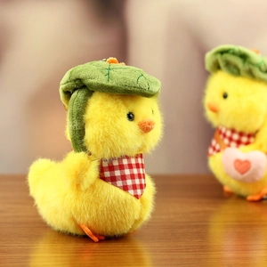 Detail of yellow plush duckling wearing green lotus leaf hat and red checkered scarf