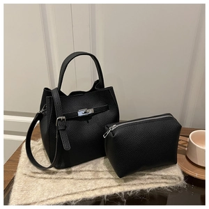 Close-up of black lychee grain bucket bag set with silver clasp and inner pouch