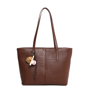 Large dark brown crocodile textured tote bag with baseball charms and long shoulder straps