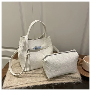 Detailed shot of white lychee texture bucket bag with metal lock and matching pouch