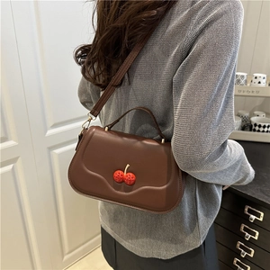 Brown faux leather crossbody bag with 3D crystal cherry charm and slim strap