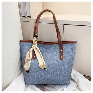 Blue felt tote bag with brown leather handles and decorative silk scarf detail