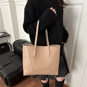 Minimalist beige matte leather tote bag for women with geometric stitching details