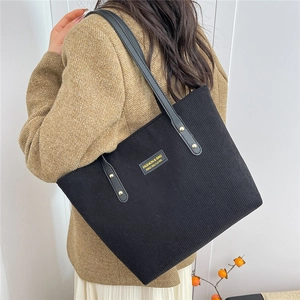 Large black corduroy tote bag for women with leather handles and yellow fashion label