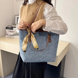 Blue denim texture tote bag with brown leather handles and decorative printed silk scarf