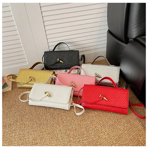 Multiple colors of woven leather baguette bags with golden twist locks and straps