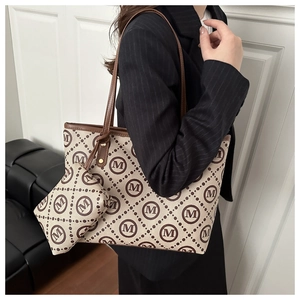 Classic beige monogram canvas tote bag and matching pouch shown on a model outfit