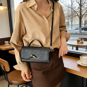 Elegant black woven leather crossbody bag with golden clasp and top handle for women
