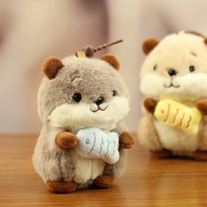 Detailed view of plush hamster keychain holding small fish with soft texture and fur details
