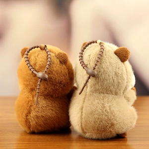 Detail view of plush hamster keychains with textured fur and brown beaded straps