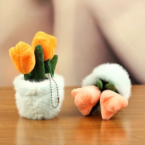 Close-up of cute plush tulip pot charms with orange petals and soft blue fur base