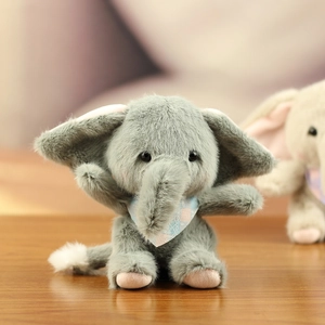 Detail of gray plush elephant keychain with pink inner ears and a blue plaid scarf