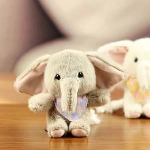 Close-up of soft plush elephant keychain with fuzzy texture and cute plaid neck scarf