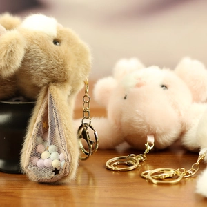 Detailed macro of plush rabbit pendant showing the mesh ear filled with colorful beads