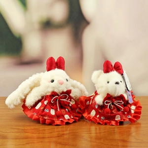 Cute plush rabbit and bear dolls in red traditional Chinese dresses with lucky patterns
