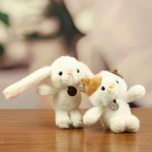 Detail of plush animal dolls with soft fur and Fashion pendant on wooden table