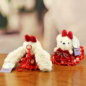 Detail of plush bunny keychains with red Chinese style outfits and golden pattern