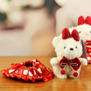 Detailed close-up of white plush bunny with red bow and traditional festive accessories