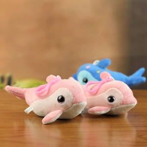 Detailed macro shot of soft pink plush dolphin keychain featuring plastic hook and wash label