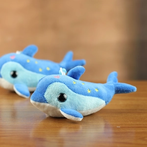 Detail of plush dolphin keychains with blue soft fabric and heart star embroidery