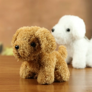 Close-up of curly teddy dog plush pendant with brown and white fluffy texture