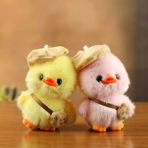 Plush yellow and pink duck keychain charms with beret hats and tiny satchels