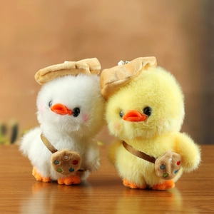 Cute plush duck keychains in white and yellow wearing berets and cookie bags