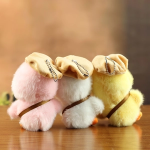 Rear view of three plush duck keychains in pink, white, and yellow with beret hats